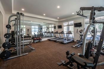 A spacious home gym with a variety of exercise equipment.